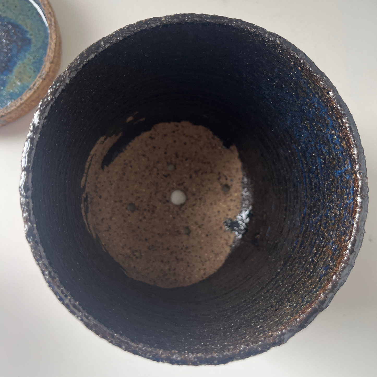 Ceramic pot with textured surface on a white background