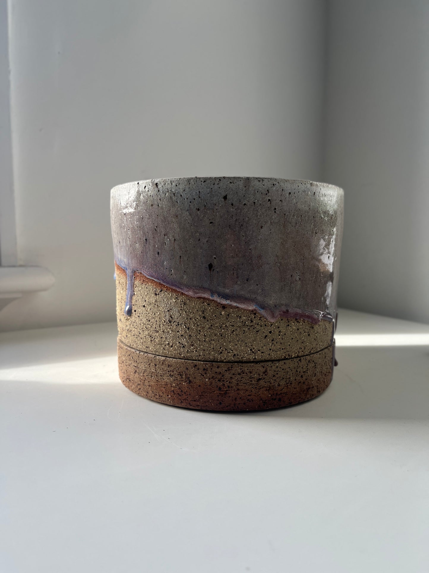 Ceramic container with two-tone design on a white surface