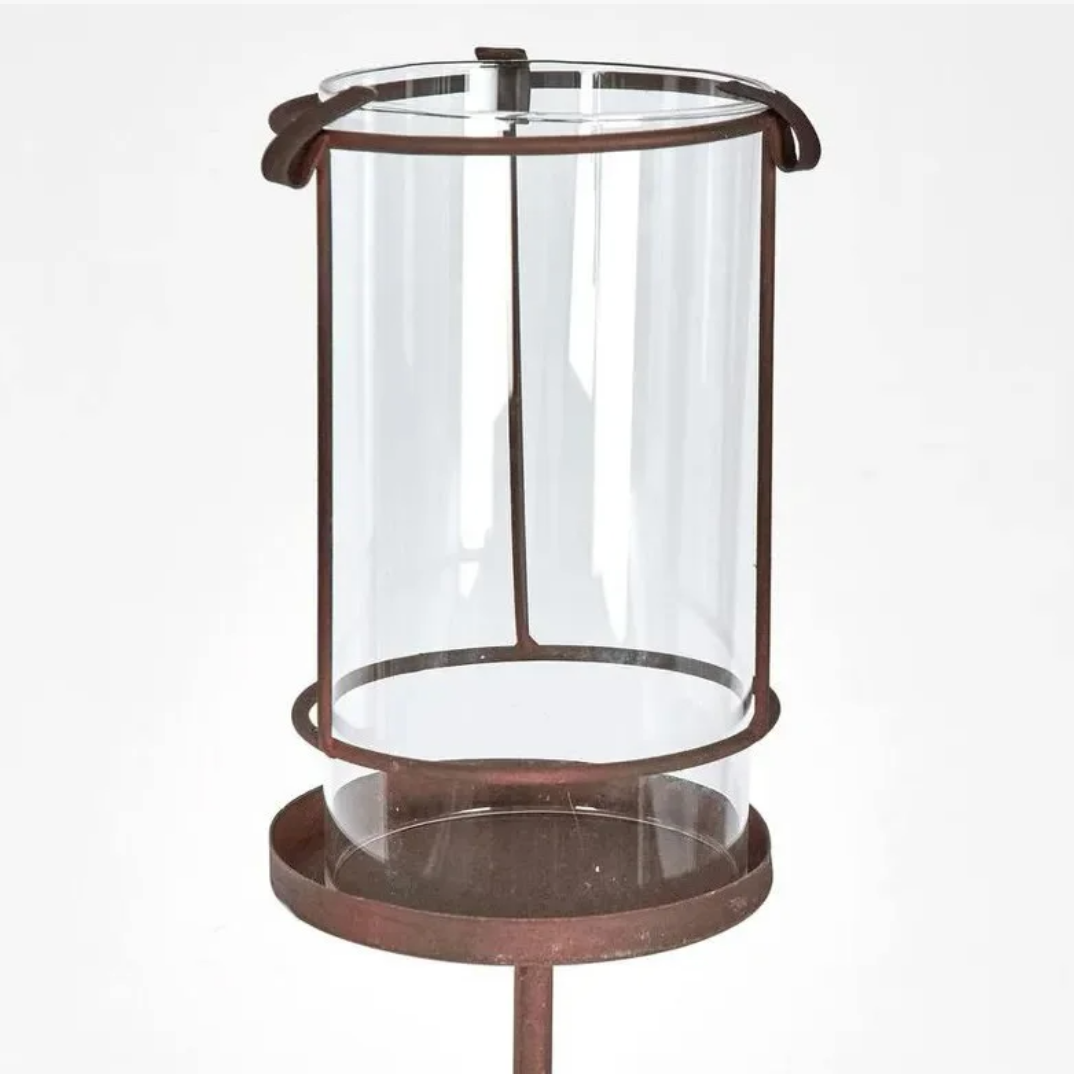 Decorative glass lantern with metal stand on a white background