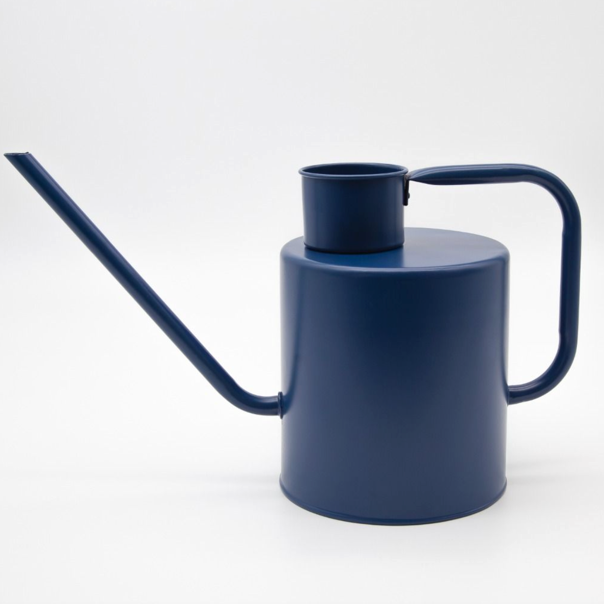 Navy blue watering can on a white background
