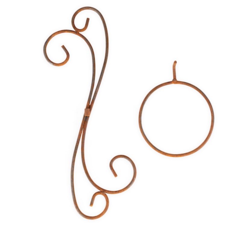 A pair of rusted metal wall hooks shaped like scrollwork and a simple oval ring, displayed on a clean white background.