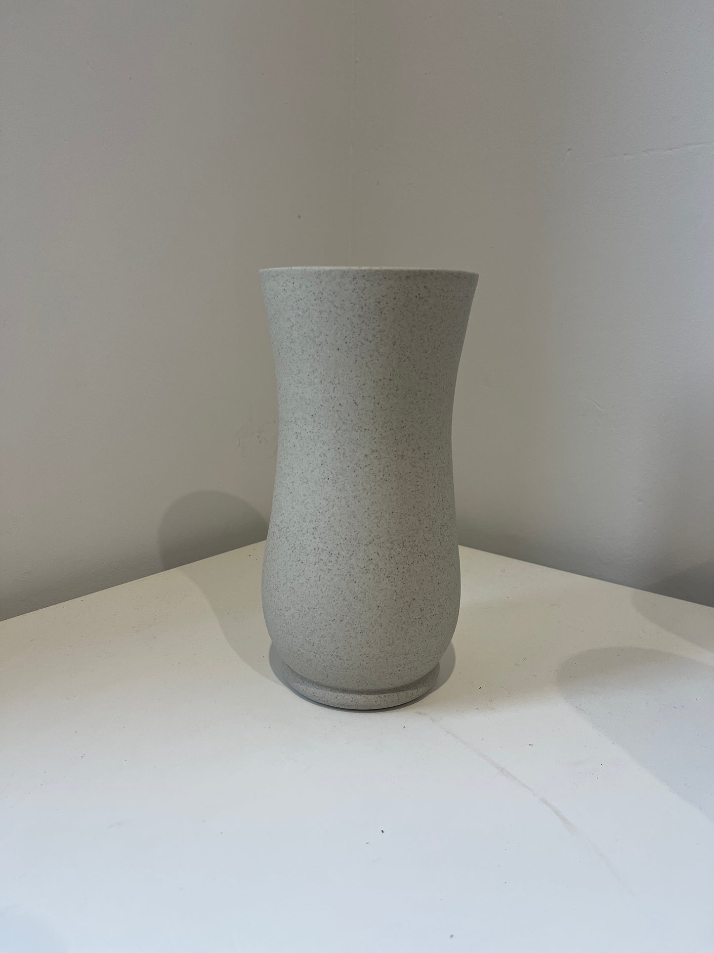 Textured gray cylindrical object against a white background