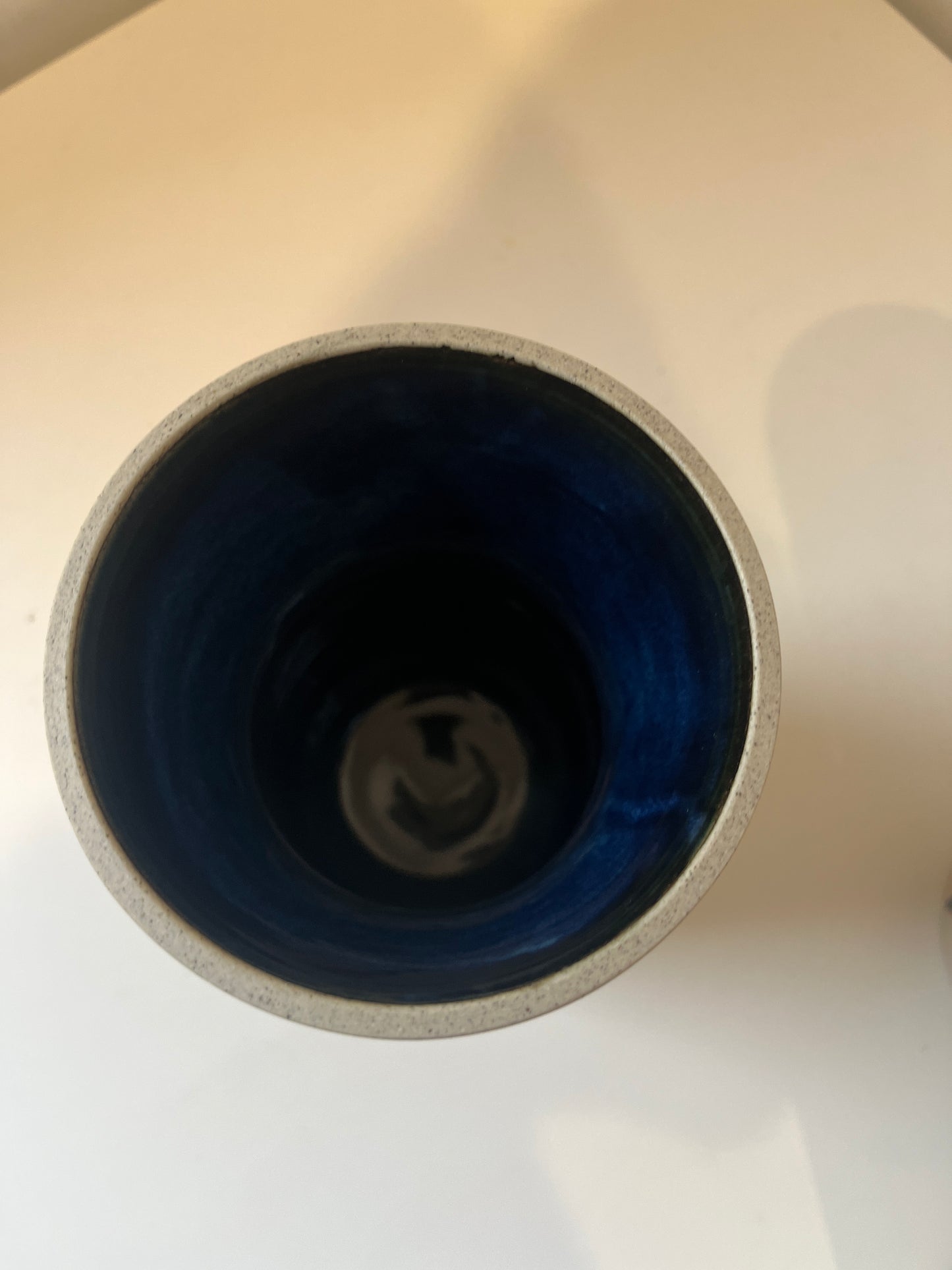 Close-up of a vase with a blue interior on a white background
