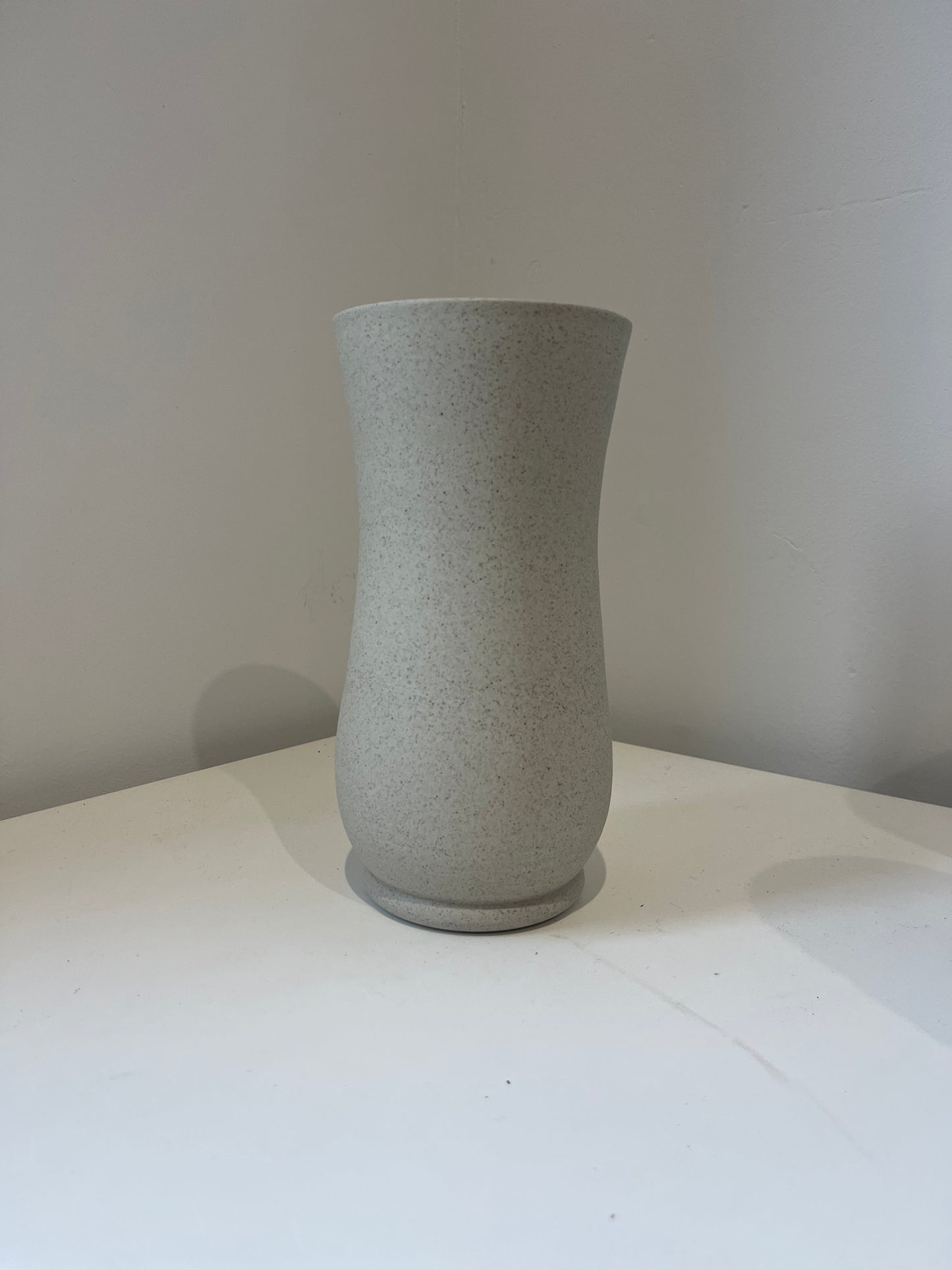 Gray textured cylindrical object on a white background
