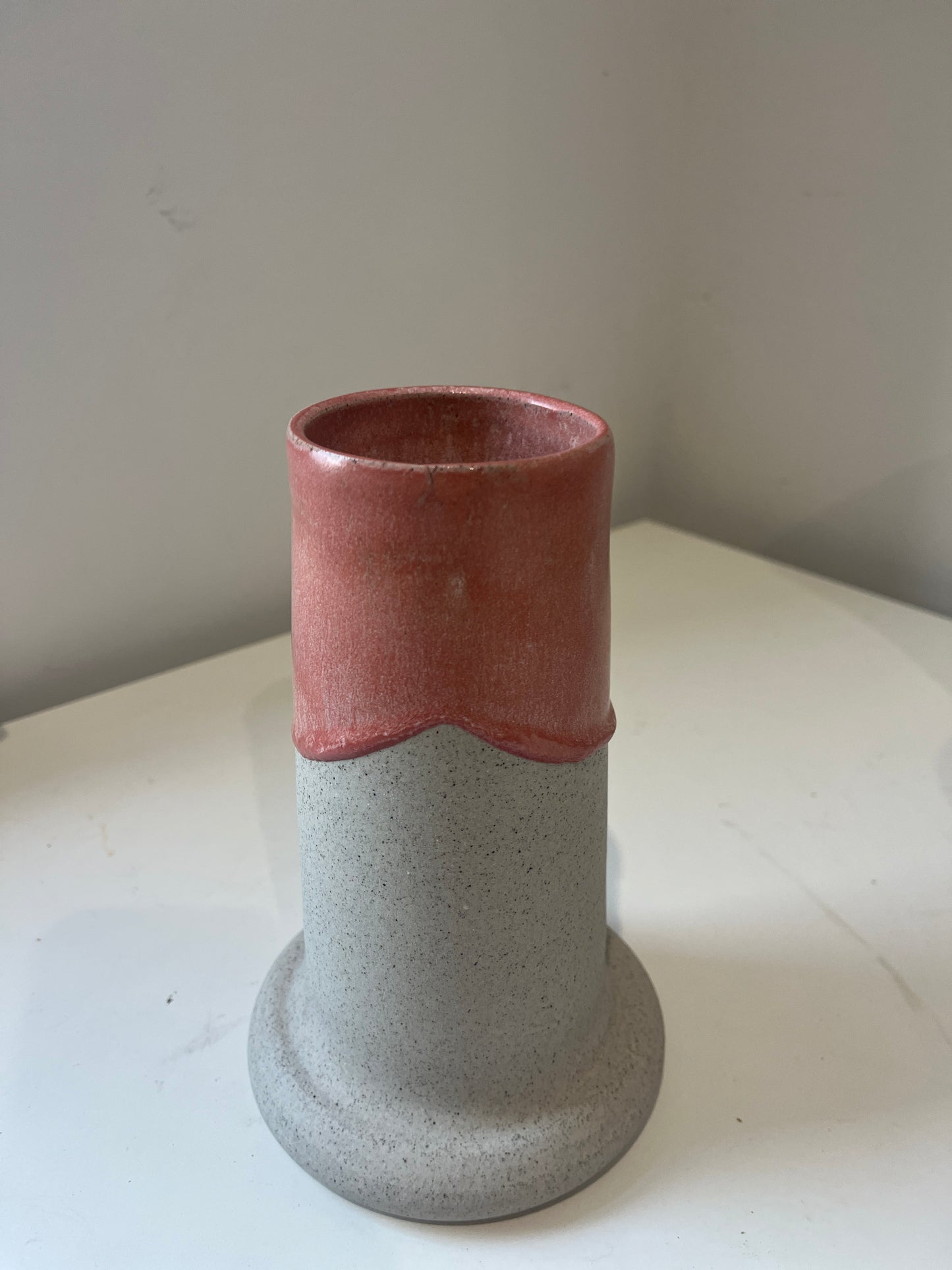 Ceramic vase with two-tone design on a white surface
