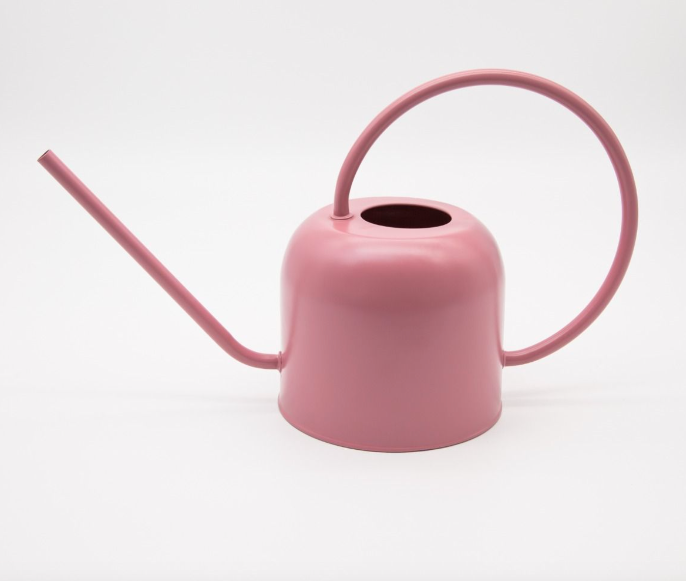 Pink watering can on a white background