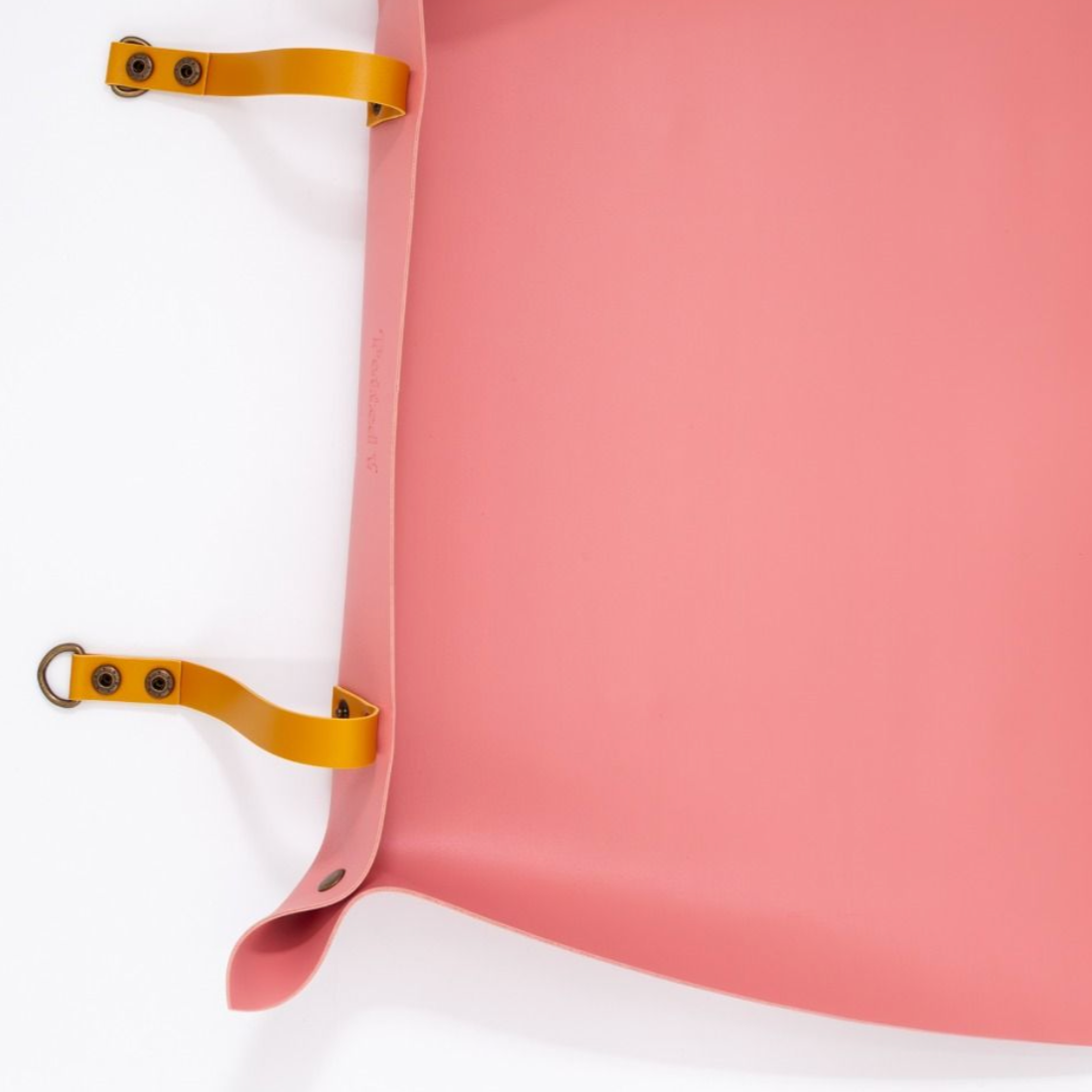 Pink repotting mat with yellow straps