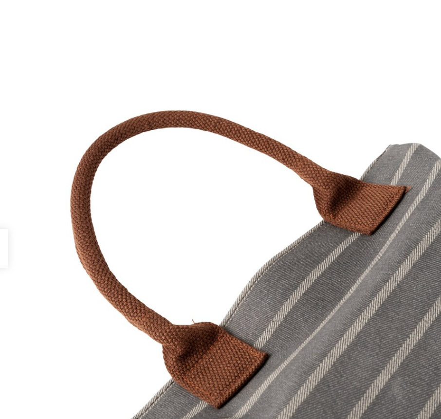 Close-up of a gray and white striped garden kneeler with brown handles on a white background