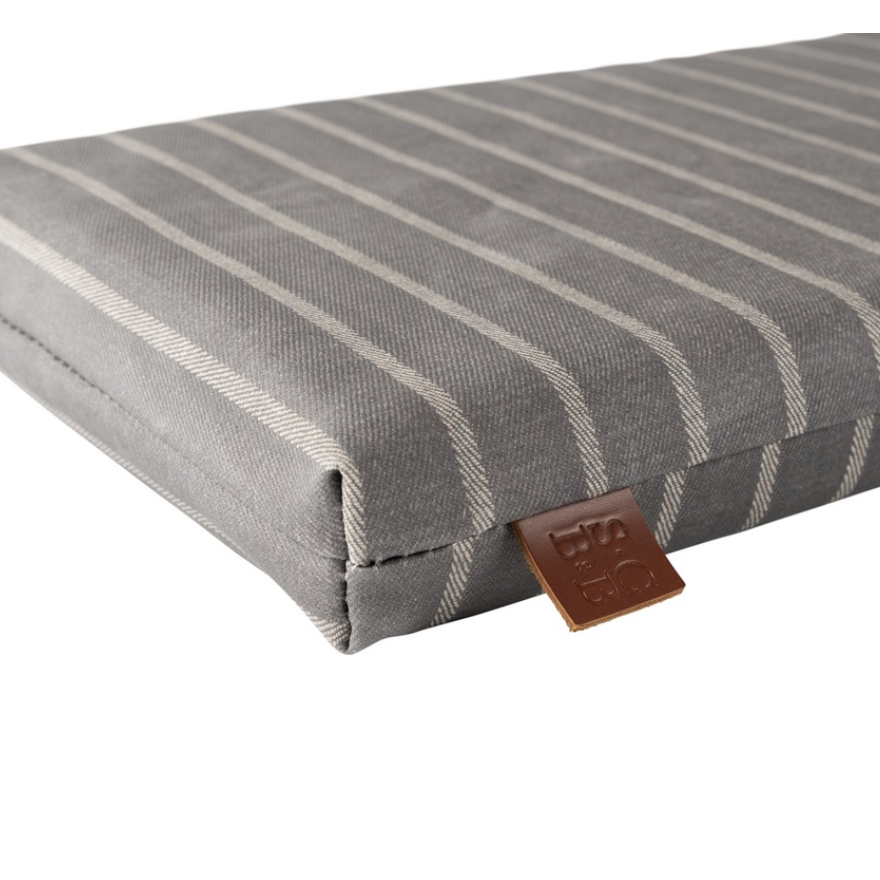 Gray striped cushion known as a garden kneeler with a brown leather tag on a white background