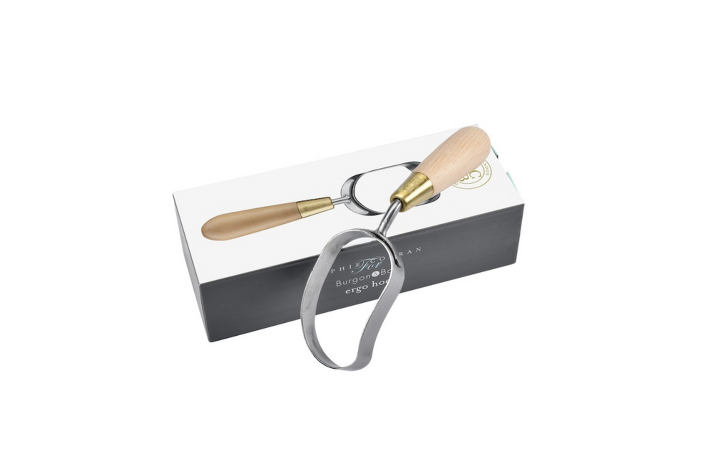 A garden hoe with a light wood handle and brass ferrule resting on its white and black branded packaging box, isolated on a white background.