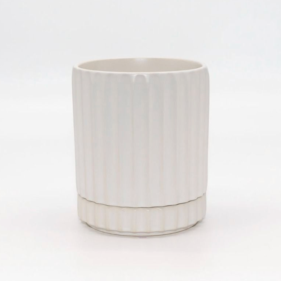 White ceramic planter with ribbed texture on a white background