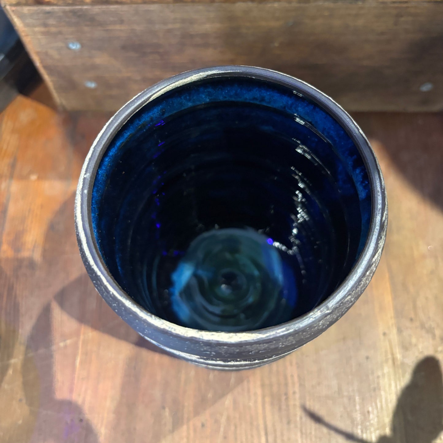 Blue ceramic cup on a wooden surface