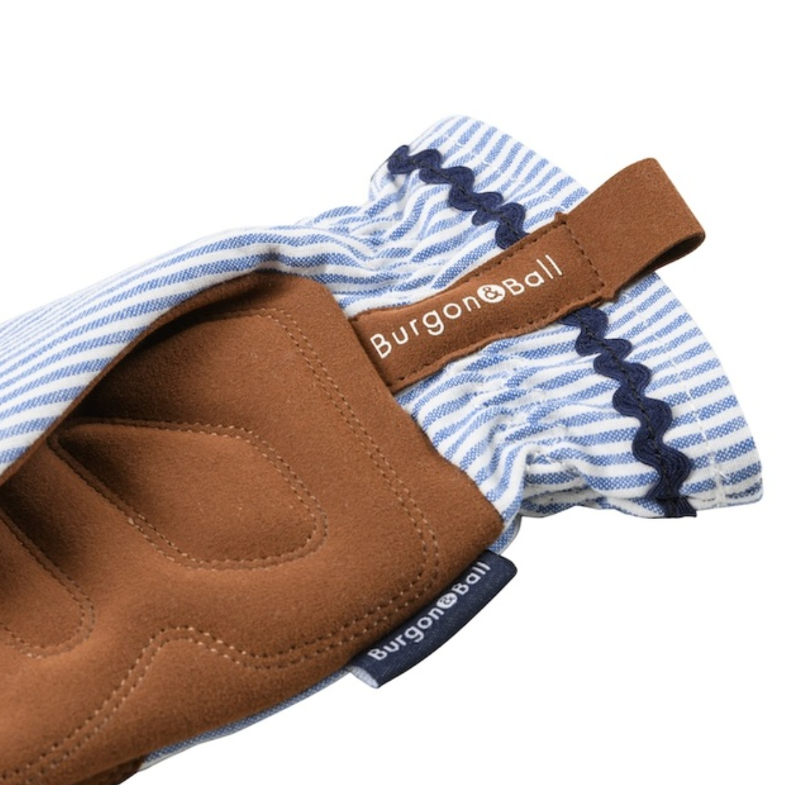 A close-up of a Burgon & Ball glove in brown suede with a blue and white striped fabric cuff, shown on a plain white background.