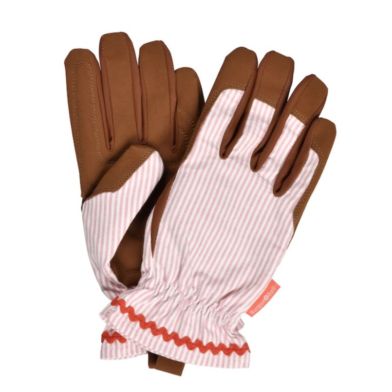 A pair of work gloves with brown palms and fingers, and pink and white striped backs with a gathered elastic cuff and red zigzag trim.