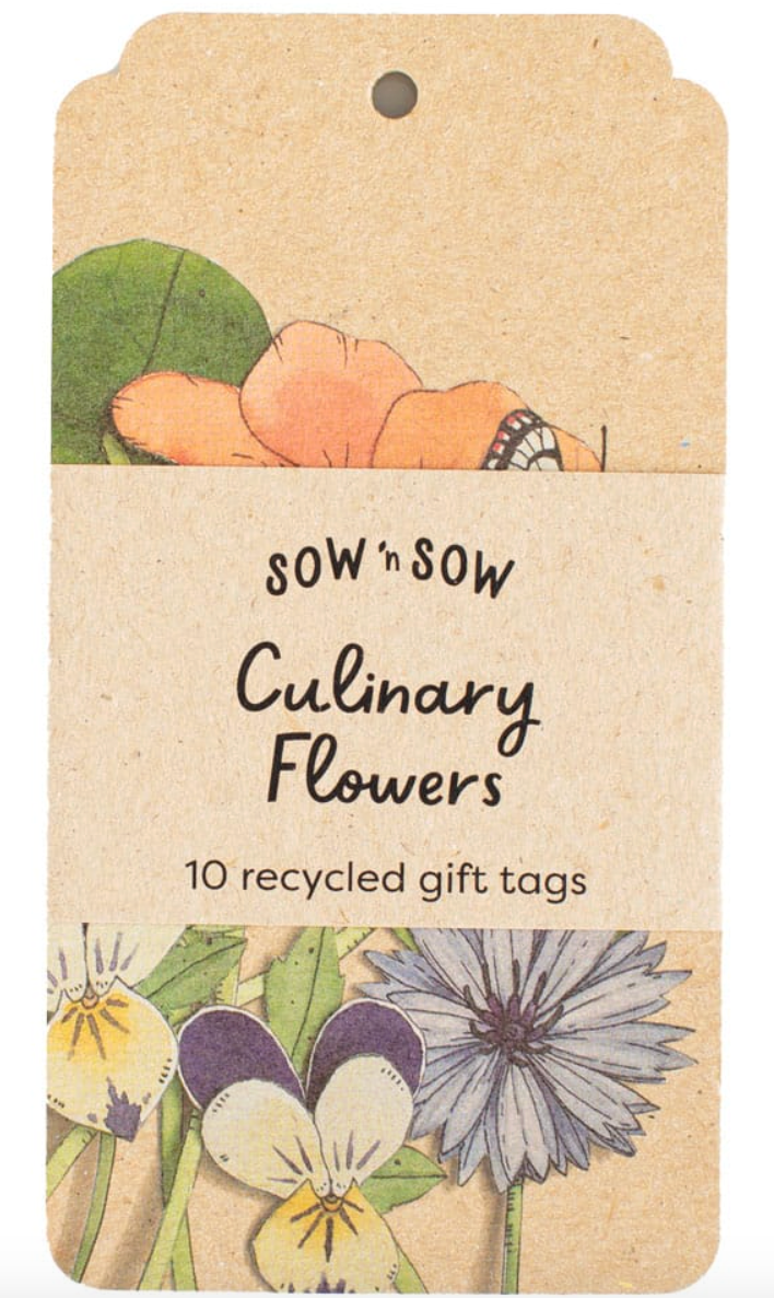 Recycled gift tags with floral designs and text on a beige background