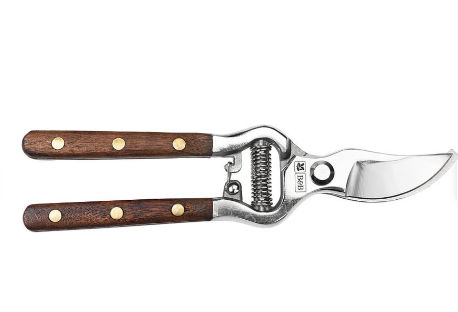Gardening shears with wooden handles on a white background