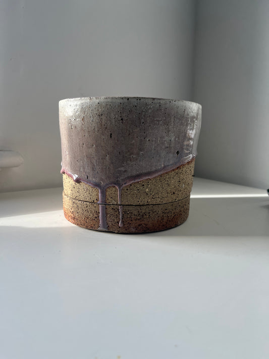 Ceramic pot with a textured surface on a white background