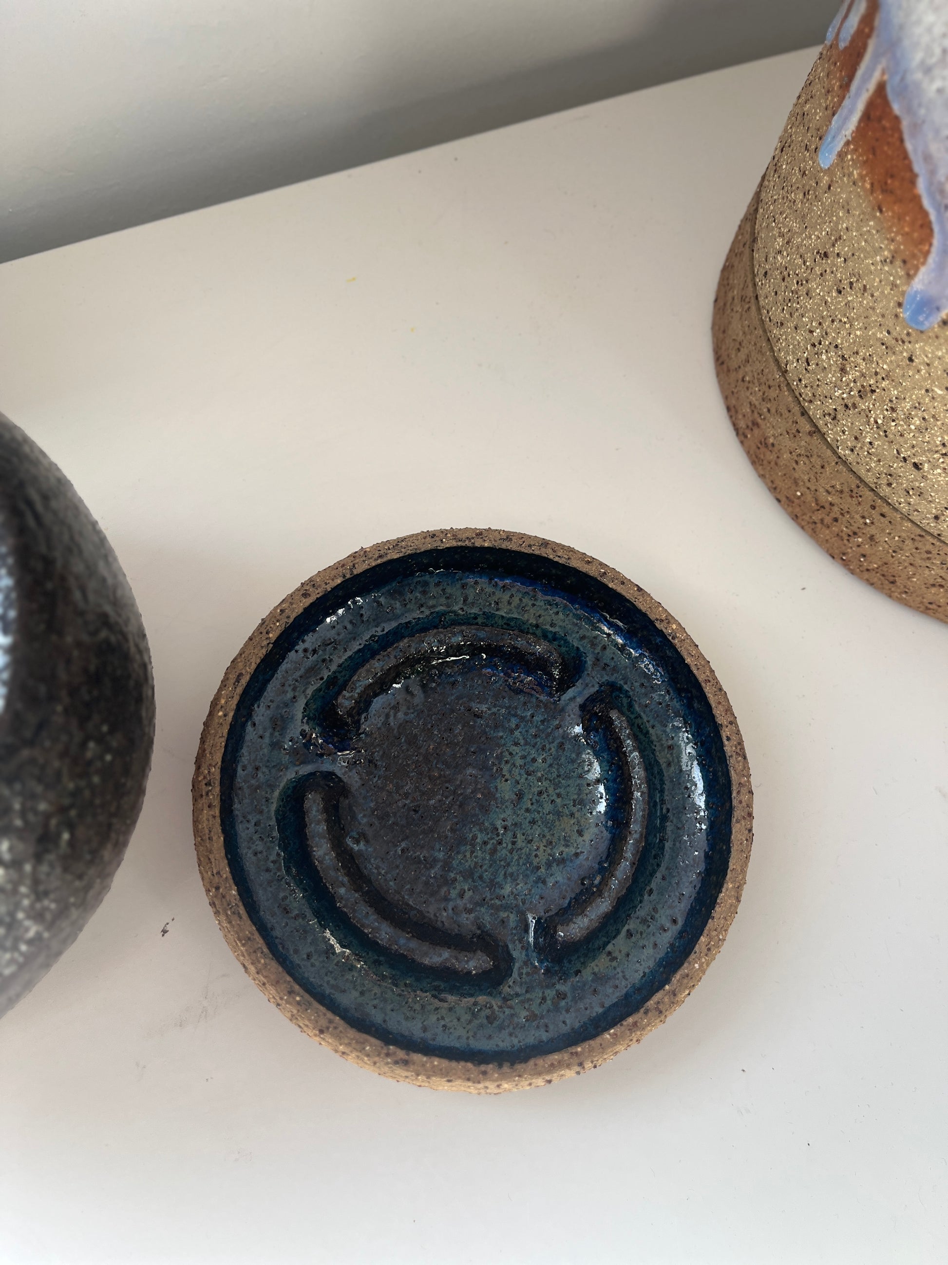 Ceramic dish with a textured surface on a white background