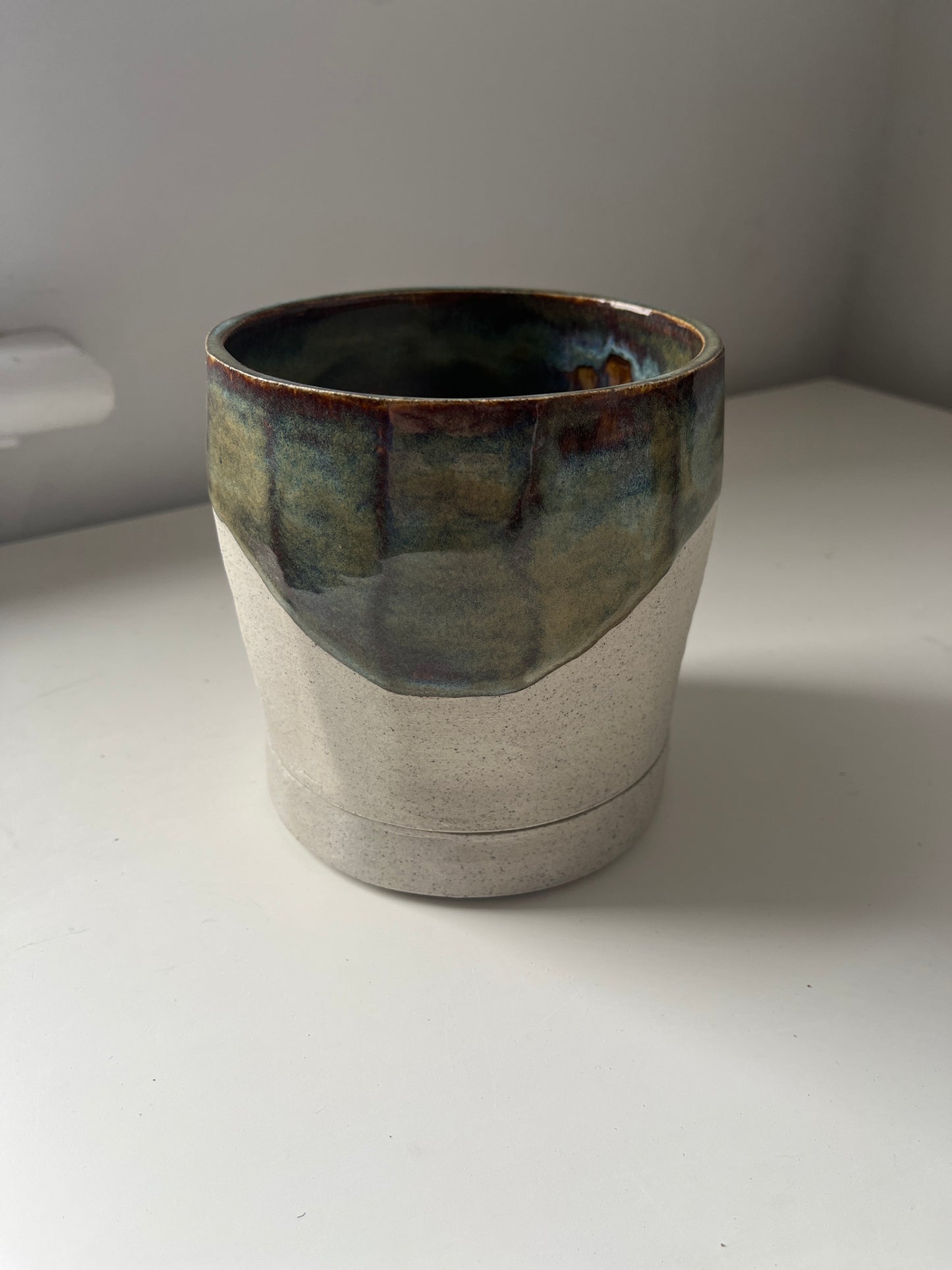 Ceramic planter with a textured surface on a white background