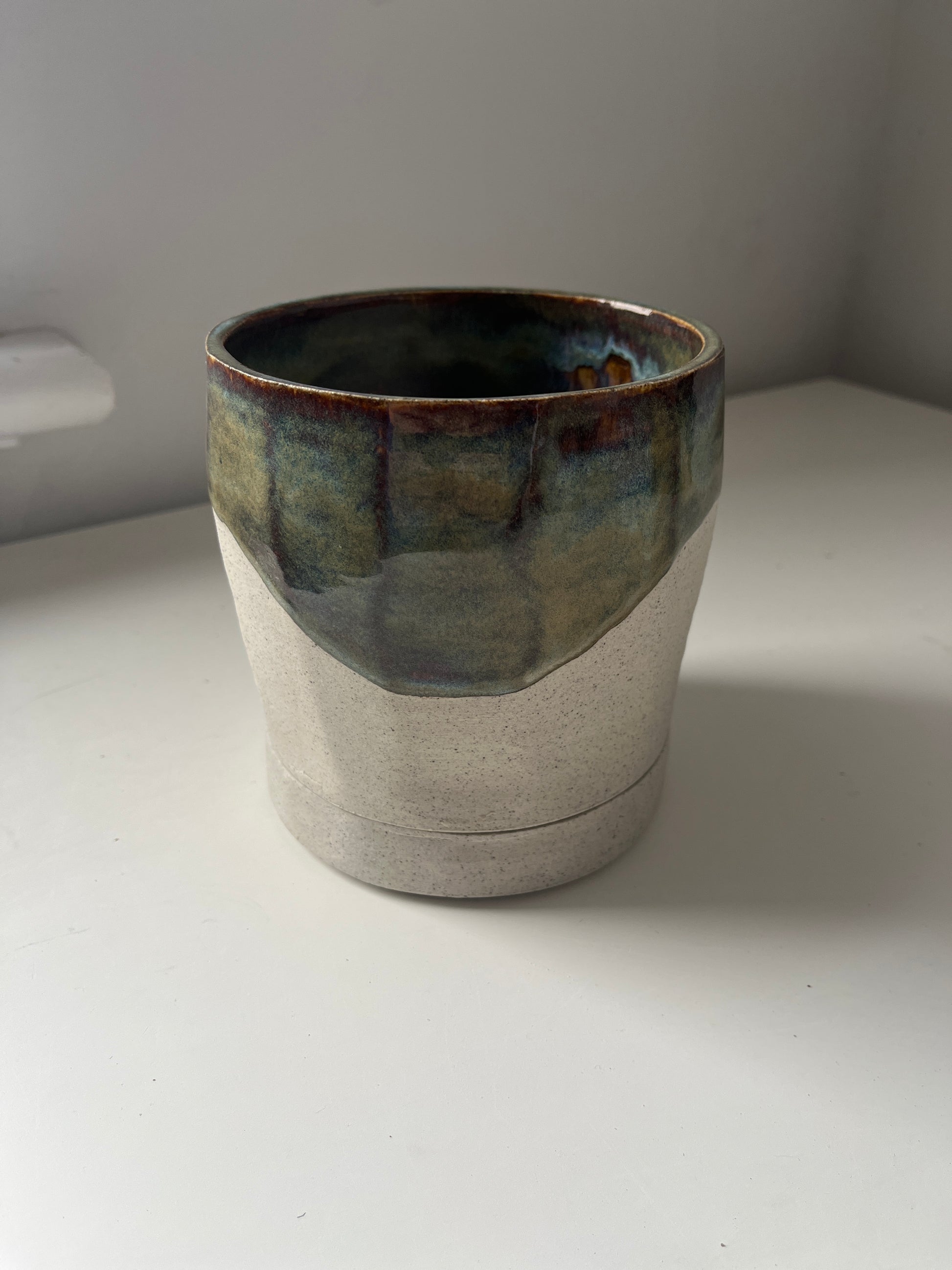 Ceramic planter with a textured surface on a white background
