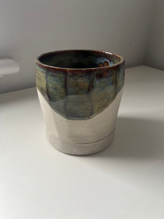 Ceramic planter with a textured surface on a white background