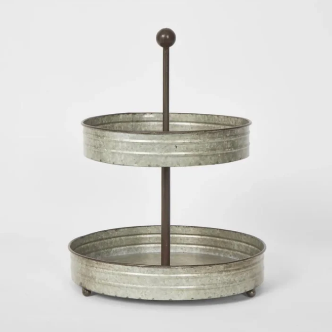 Two-tier metal serving tray on a white background