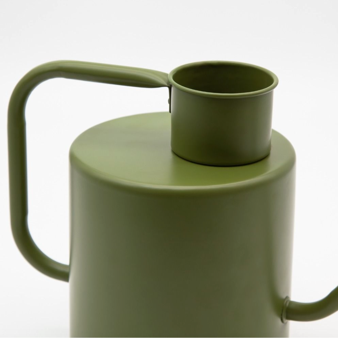 Green watering can on a white background