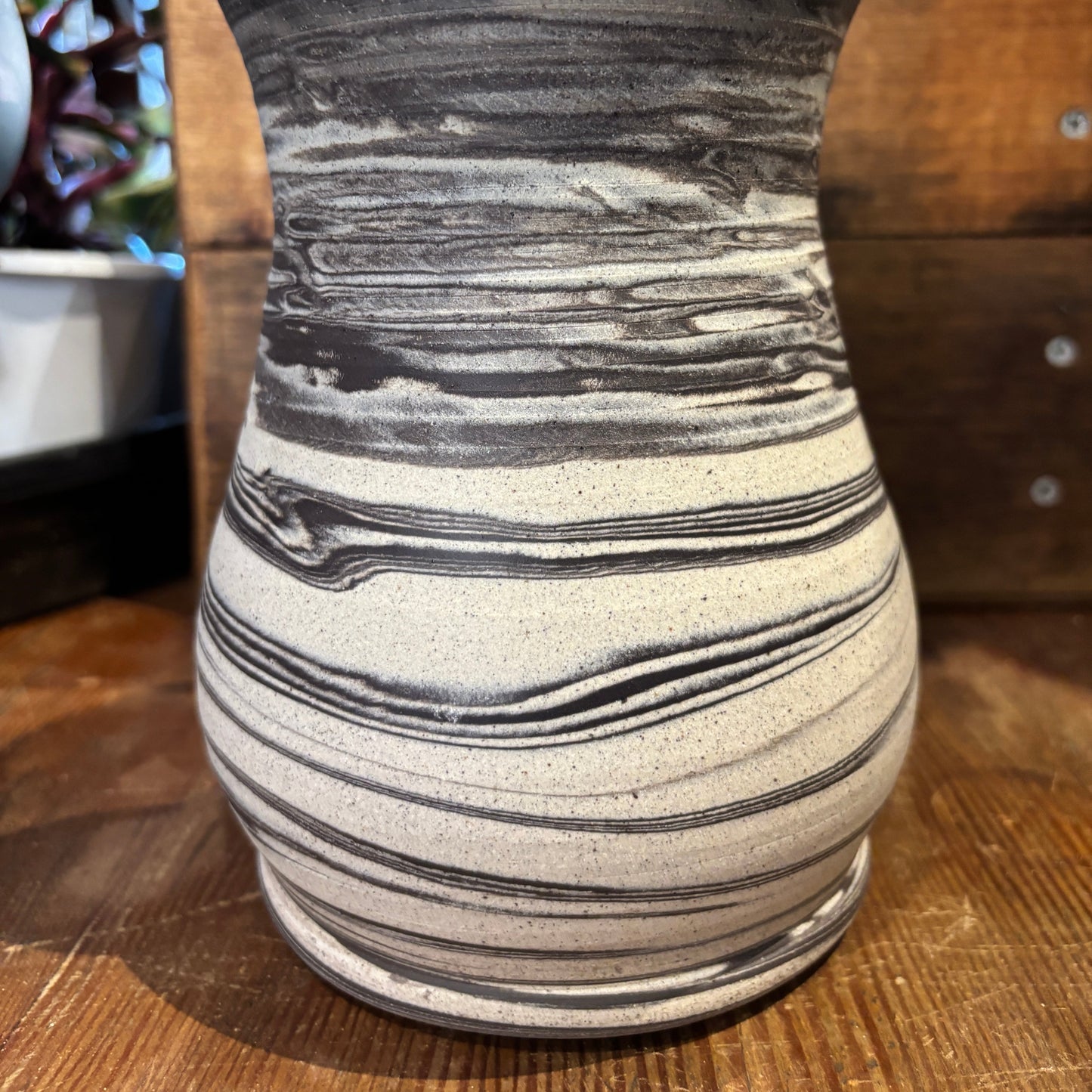 Marbled vase with black and white marbled pattern on a wooden surface