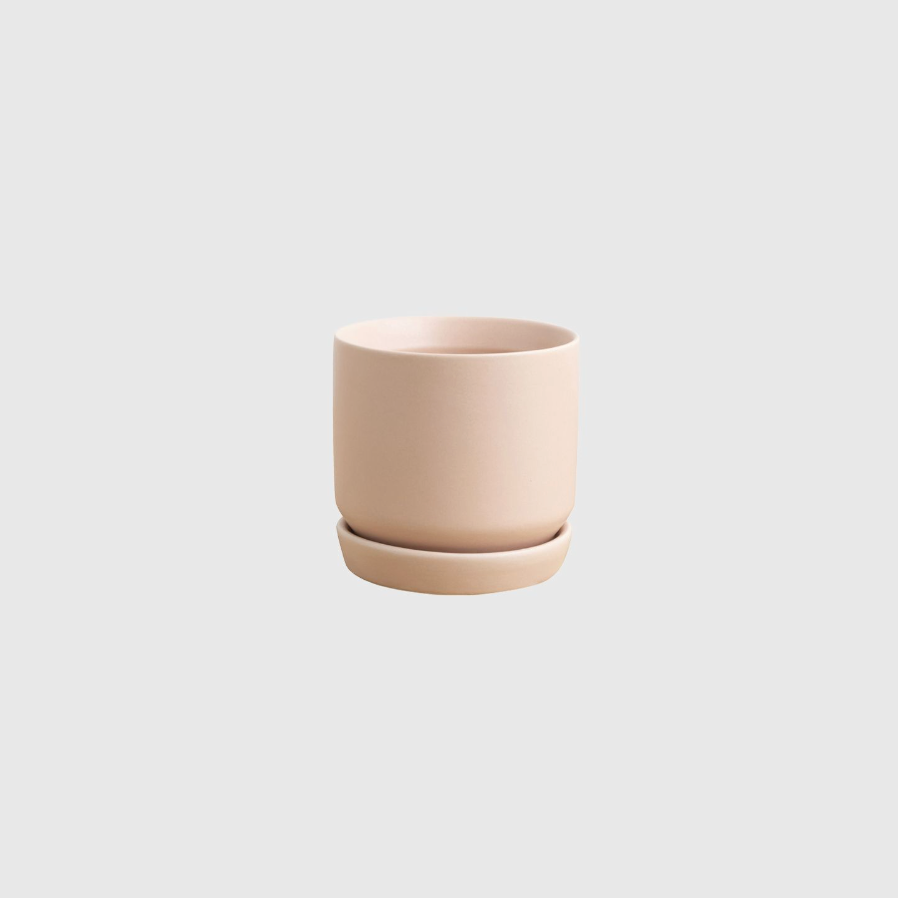 Peach ceramic cup on a light gray background