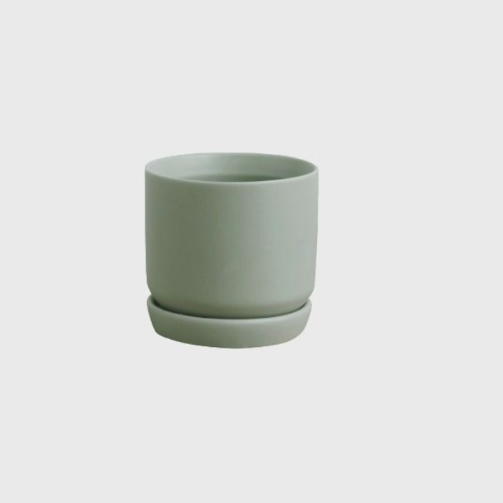 Green ceramic cup on a white background