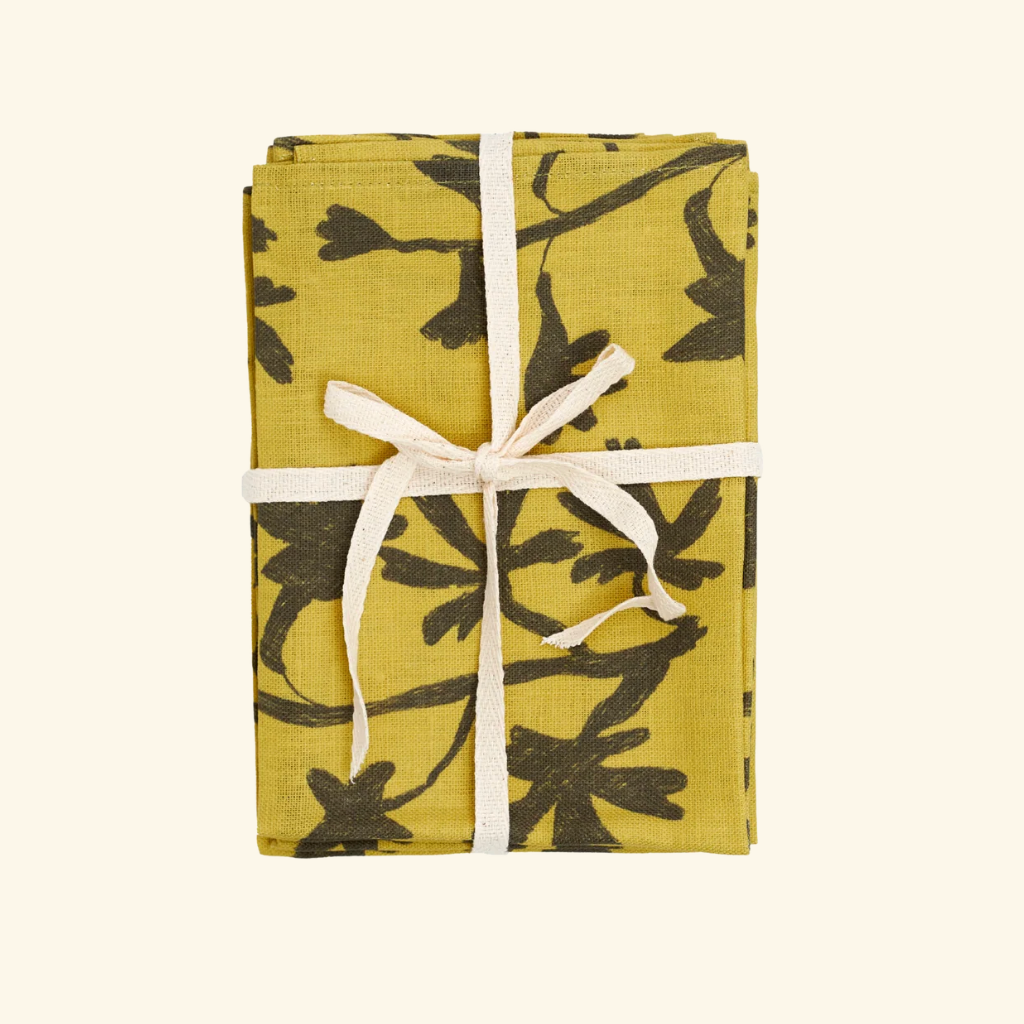 Packaged product with yellow and black floral pattern on a white background
