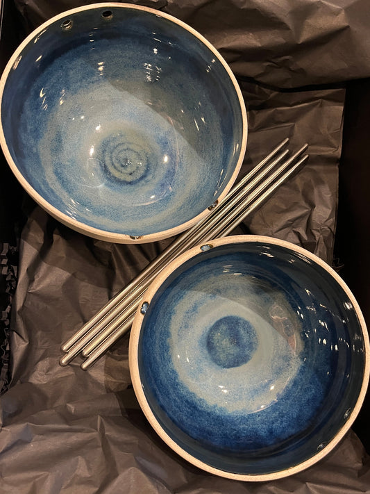 Two handmade blue and white bowls with chopsticks
