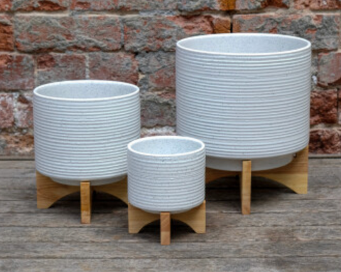 White Ribbed Ceramic Pot on Wooden Stand