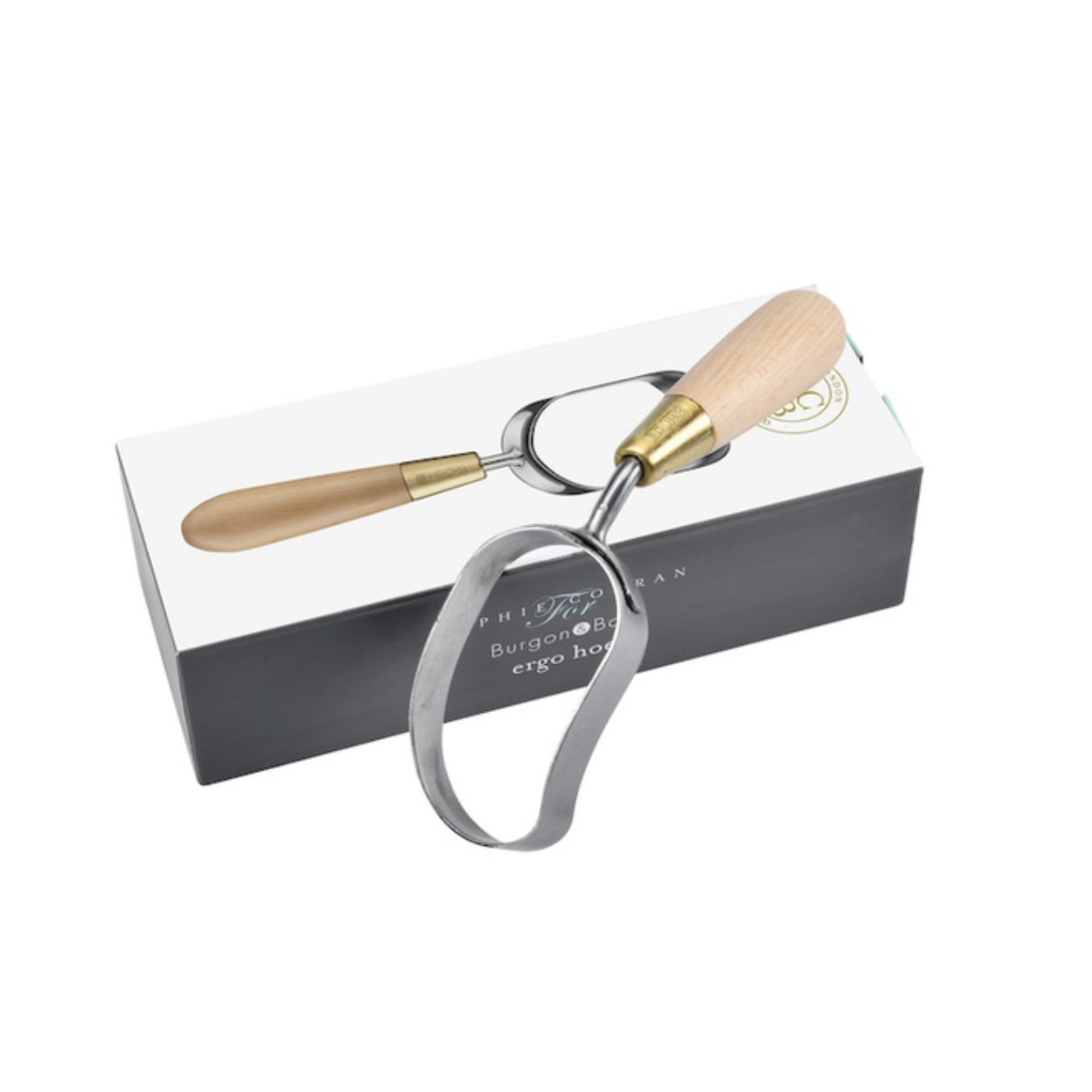 A garden hoe with a light wood handle and a silver metal loop, resting on top of its white and black presentation box against a white background.