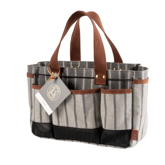Striped tote bag with brown handles and a visible brand tag on a white background
