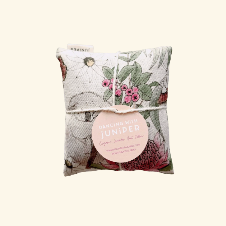 Decorative pillow with floral pattern and 'Dancing with Juniper' label on a white background