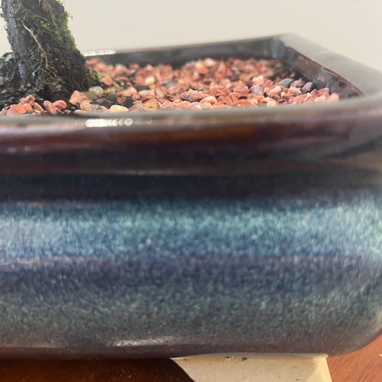 Blue ceramic pot with a textured surface on a wooden surface