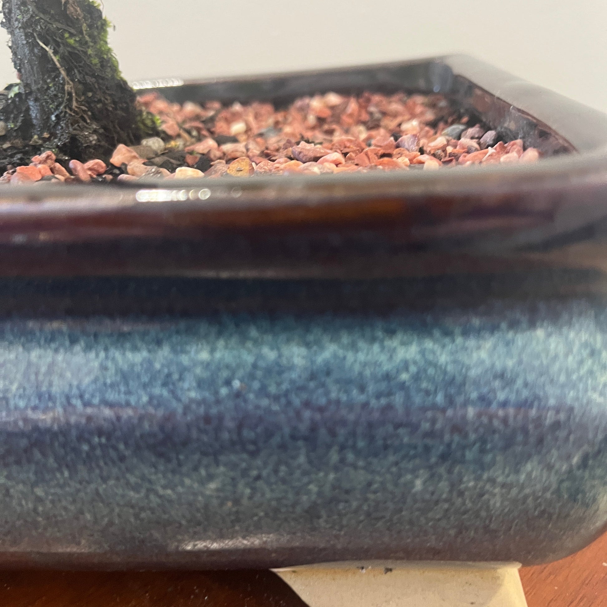 Blue ceramic pot with a textured surface on a wooden surface