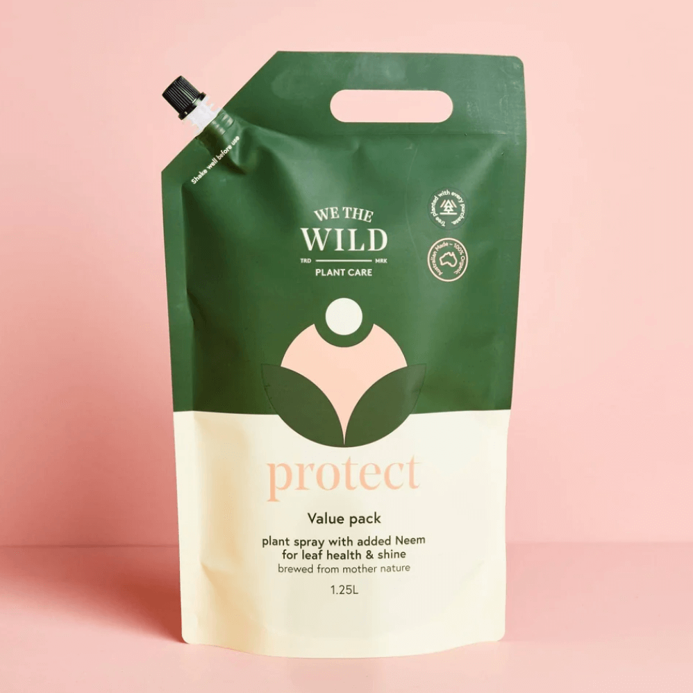 A pouch of 'Protect Spray' by We The Wild, a bioactive multipurpose plant care product, against a pink background.