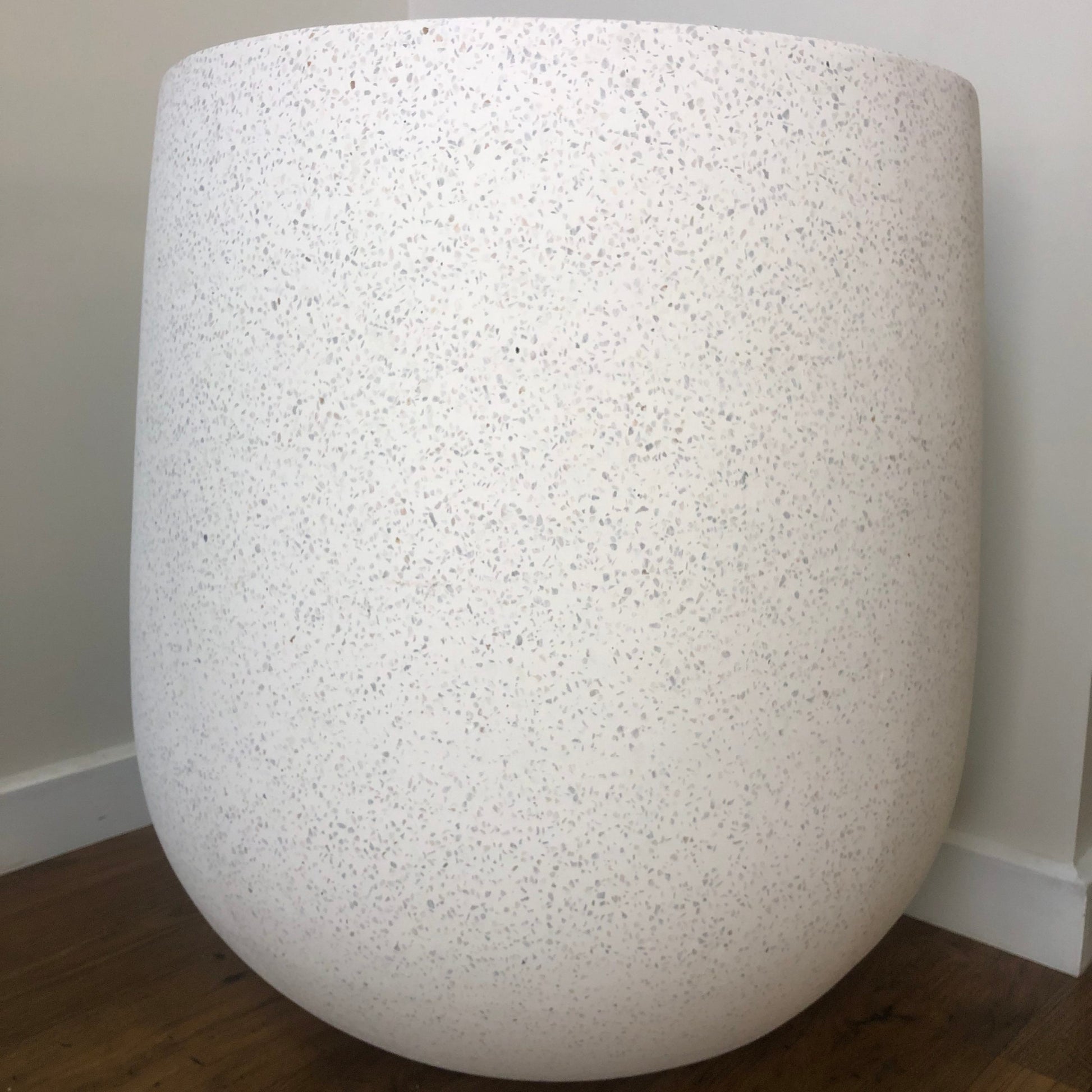 White textured vase against a plain wall
