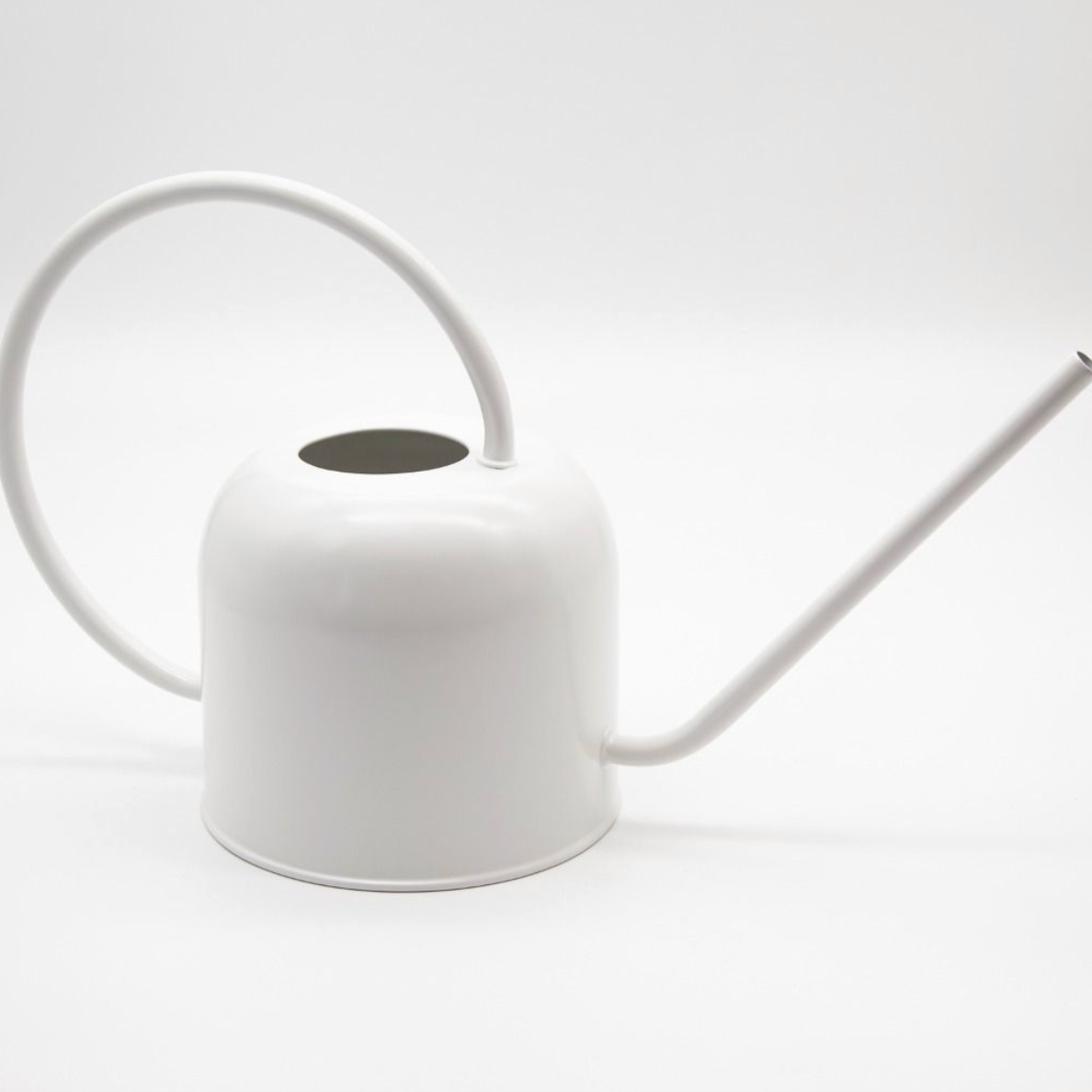 White watering can on a white background